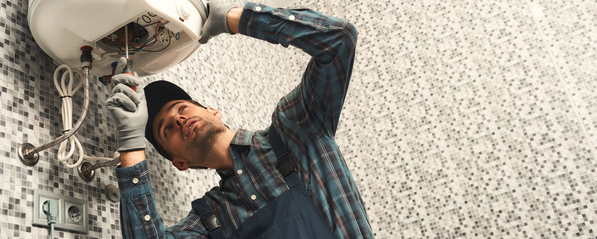 plumber-installing-electric-heating-boiler-young-h-DF8RFV4 plumber-installing-electric-heating-boiler-young-h-DF8RFV4